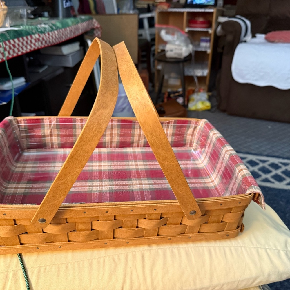 Longaberger Plaid Lined Woven Basket with plastic protector. Approx 15.5”x9.5”